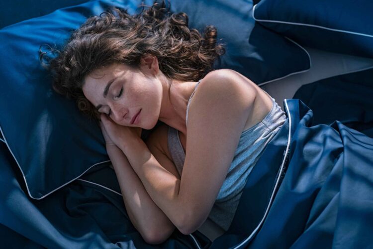 Peaceful night scene showing a bedroom with dim lighting, tart cherry juice, and magnesium capsules — representing effective sleep hygiene and natural sleep solutions.