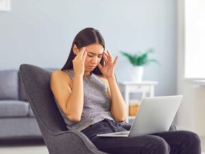 Person lying on a couch, looking exhausted and overwhelmed — representing Chronic Fatigue Syndrome