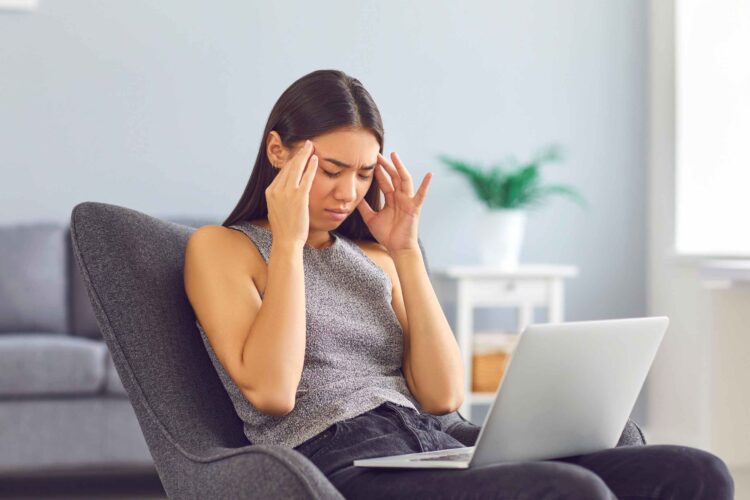 Person lying on a couch, looking exhausted and overwhelmed — representing Chronic Fatigue Syndrome