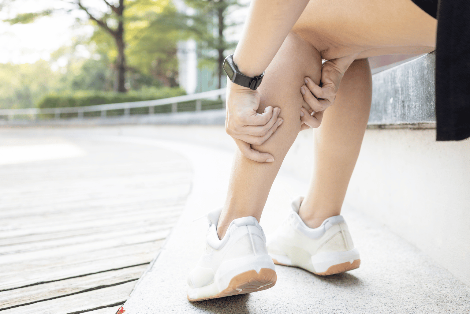 Person holding a painful calf, illustrating leg muscle ache while taking a cholesterol‑lowering drug (statin).